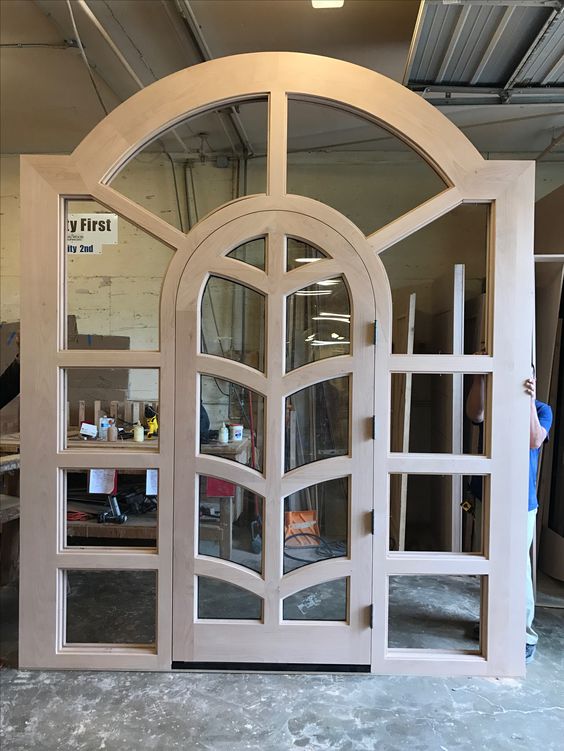 Arched Top Wooden Door with Wrought Iron Accents