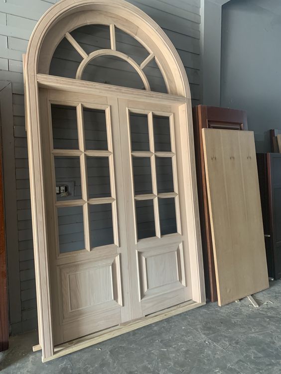 Arched Top Wooden Door with Wrought Iron Accents
