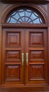 Arched Top Wooden Door with Wrought Iron Accents