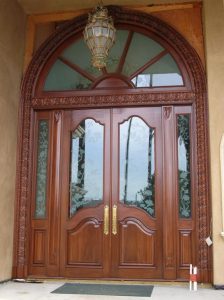 Arched Top Wooden Door with Wrought Iron Accents